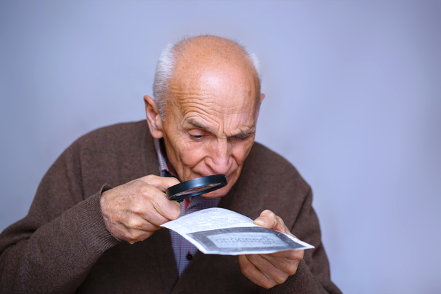 Old,Man,With,Low,Vision,Reading,A,Text,With,A